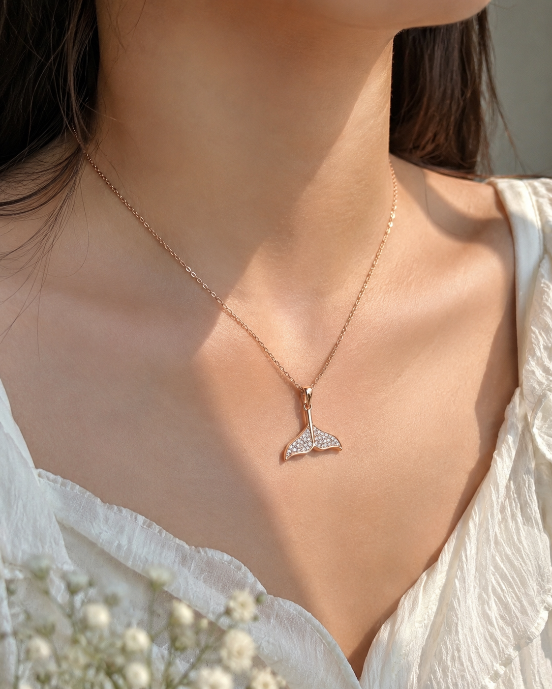 Model wearing mermaid tail necklace