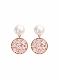 Close-up of pearl-look studs and sparkling circular crystal drops