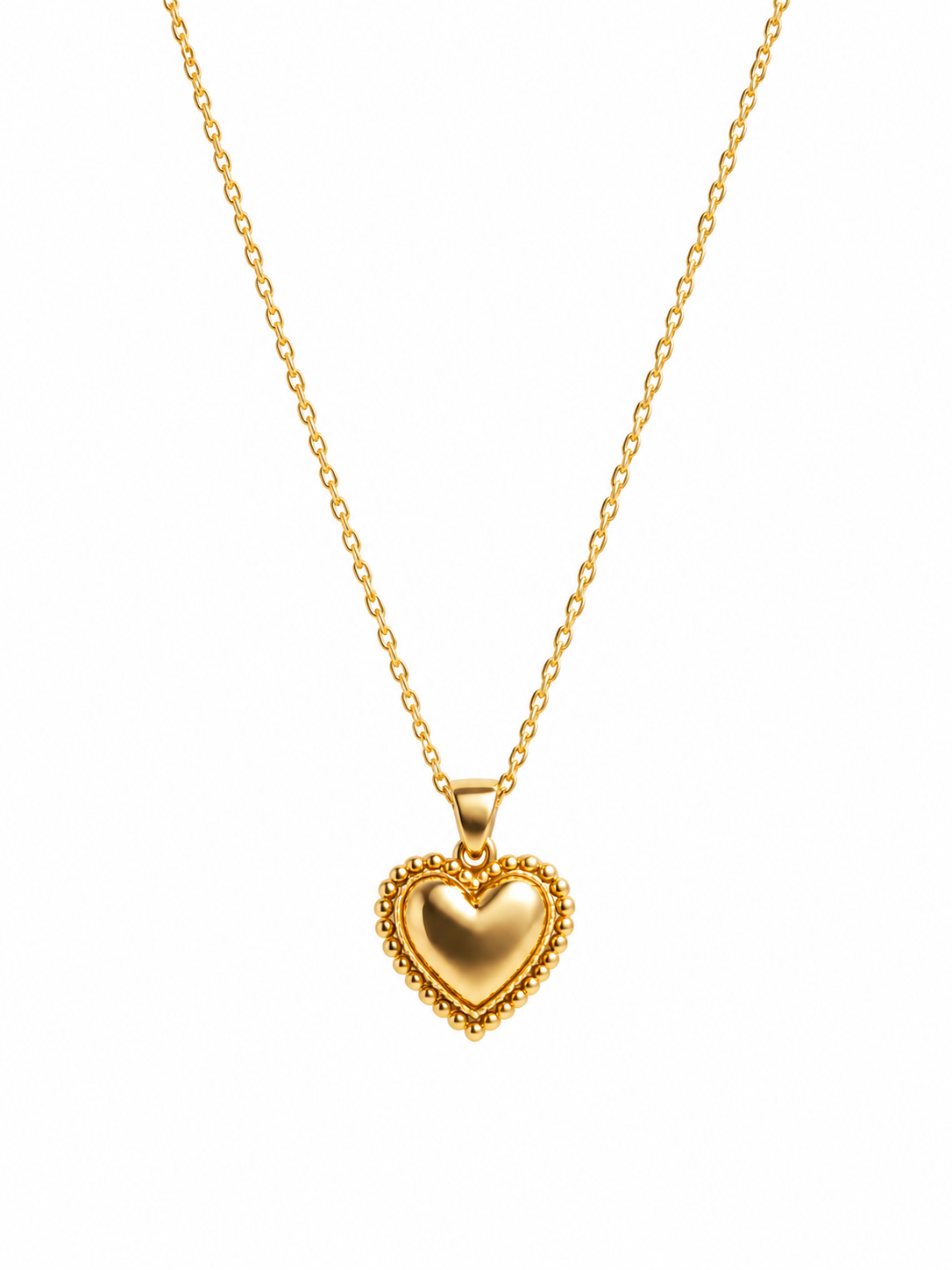 Gold-tone heart pendant necklace on white background