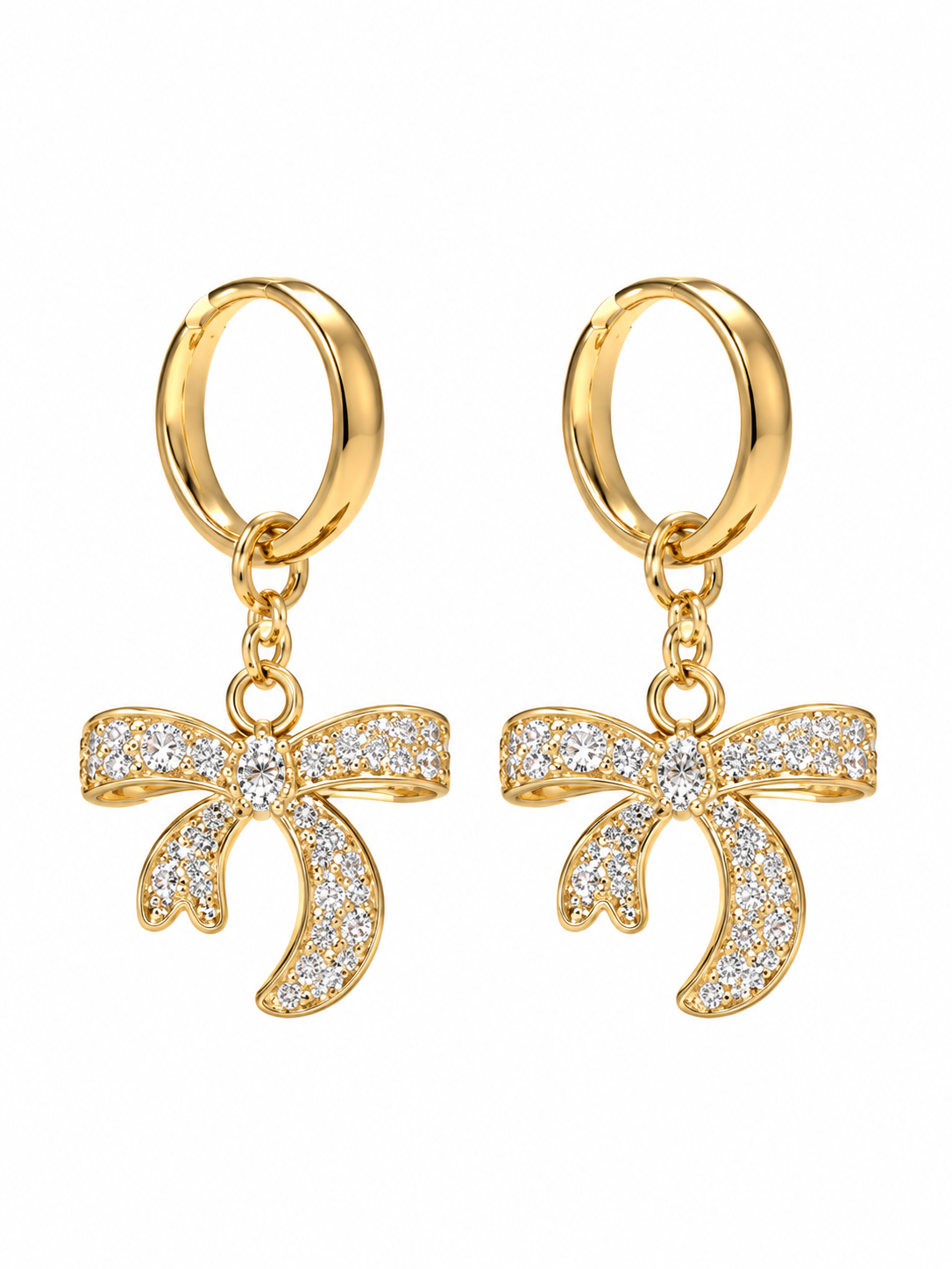 Pair of gold-tone hoop earrings with sparkling bow charms on white background