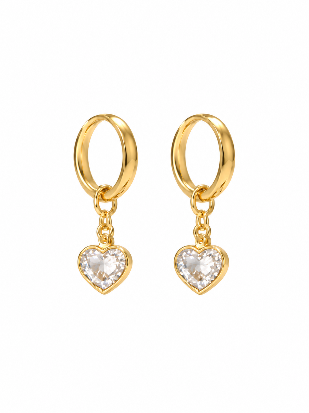 Pair of gold-tone hoop earrings with clear heart-shaped charms on white background