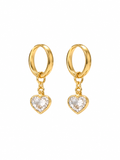 Pair of gold-tone hoop earrings with clear heart-shaped charms on white background