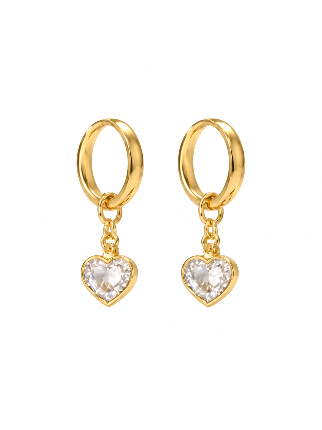 Pair of gold-tone hoop earrings with clear heart-shaped charms on white background