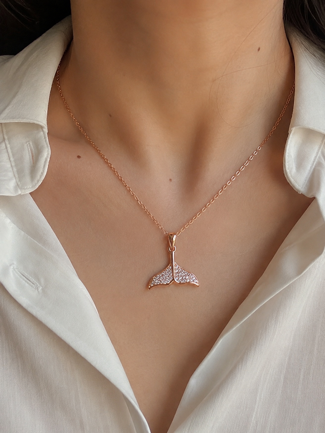 Model wearing mermaid tail necklace and stud earrings